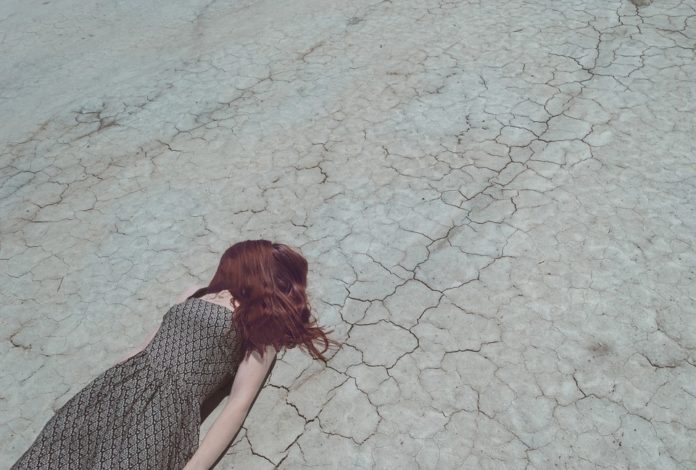metaphor, falling down, failure, dry, stressed, cracked, panic, anxiety, broken, loss, woman, red hair, dress, laying down, falling, crisis, depression, down, injured, stumbling